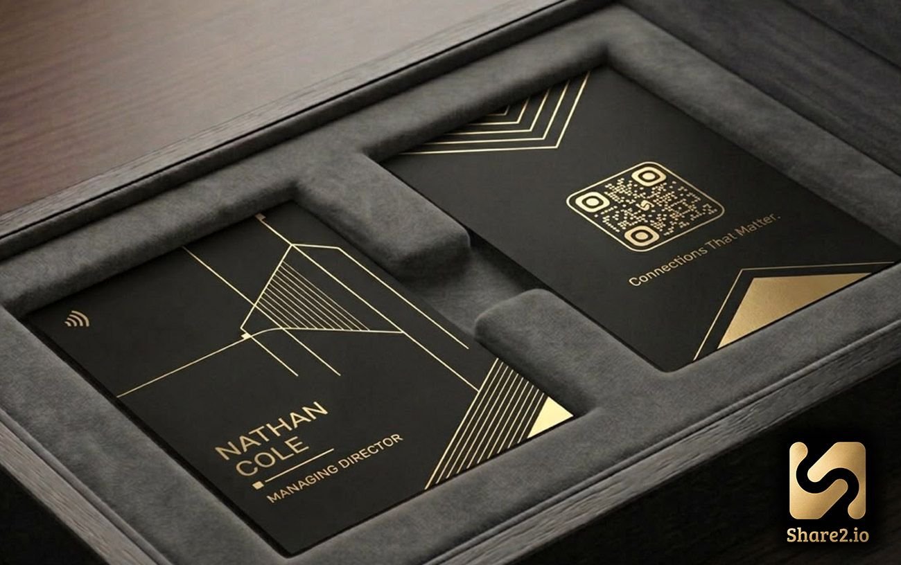 Vertex design — matte black NFC business card with converging gold wireframe lines and a gold-foil triangle, presented in a grey suede gift box